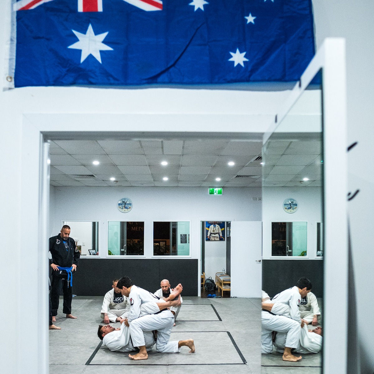 Adults practising Brazilian Jiu Jitsu under focused coaching at Lasco in Varsity Lakes